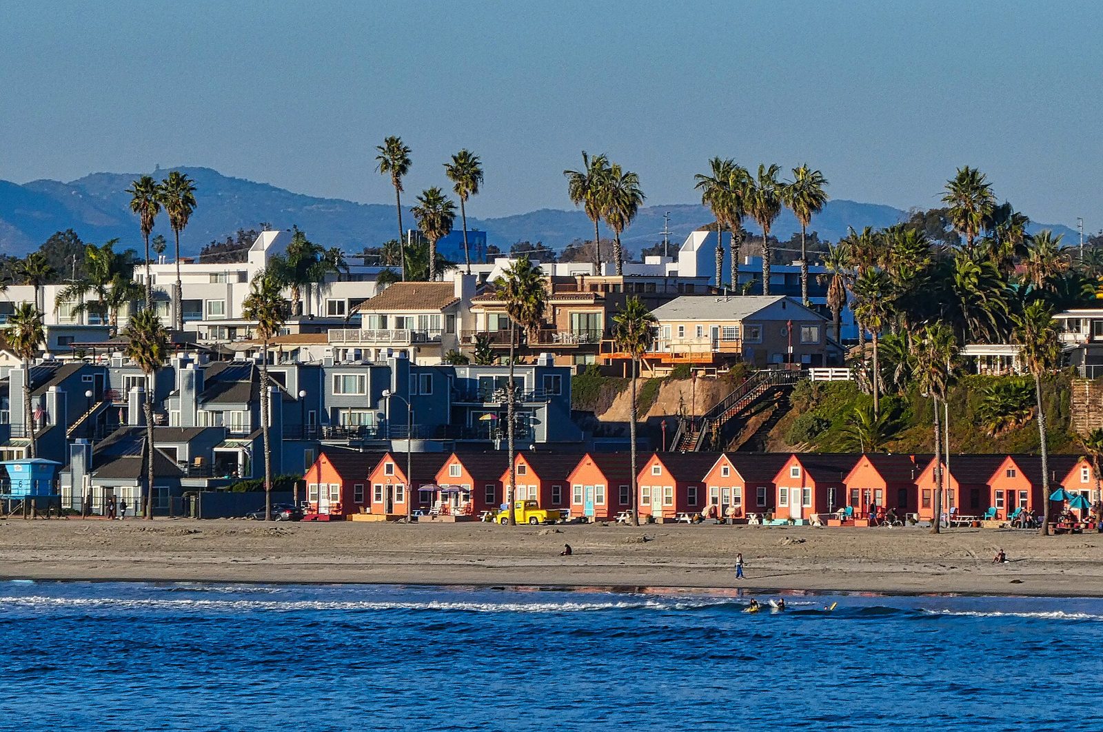 Oceanside beach cottages and palm trees along the Strand